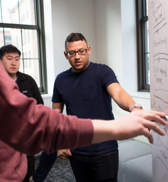 three associates at a whiteboard